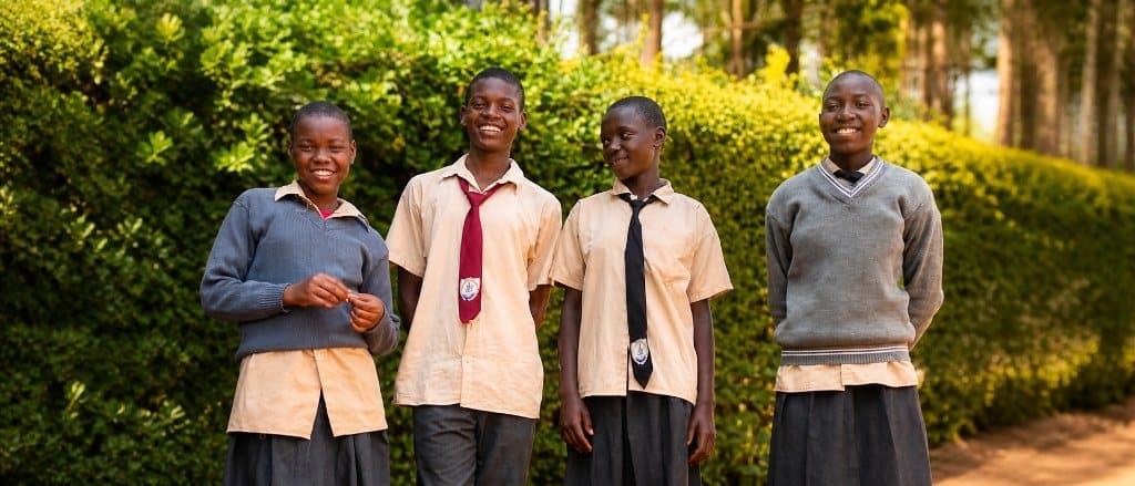 Four students of Bogetenga Children's Home in school uniforms